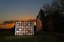 At dusk, the centennial quilt is pictured in front of historic Old Central on the OSU campus in Stillwater.  - 