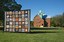 The centennial quilt shines in the daylight in front of the historic building, Old Central, on the OSU campus in Stillwater. - 