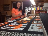 A former 4-Her who enjoyed completing sewing projects, Charlotte Tucker is a professional quilter whose family also farms about 800 acres in Major County. 